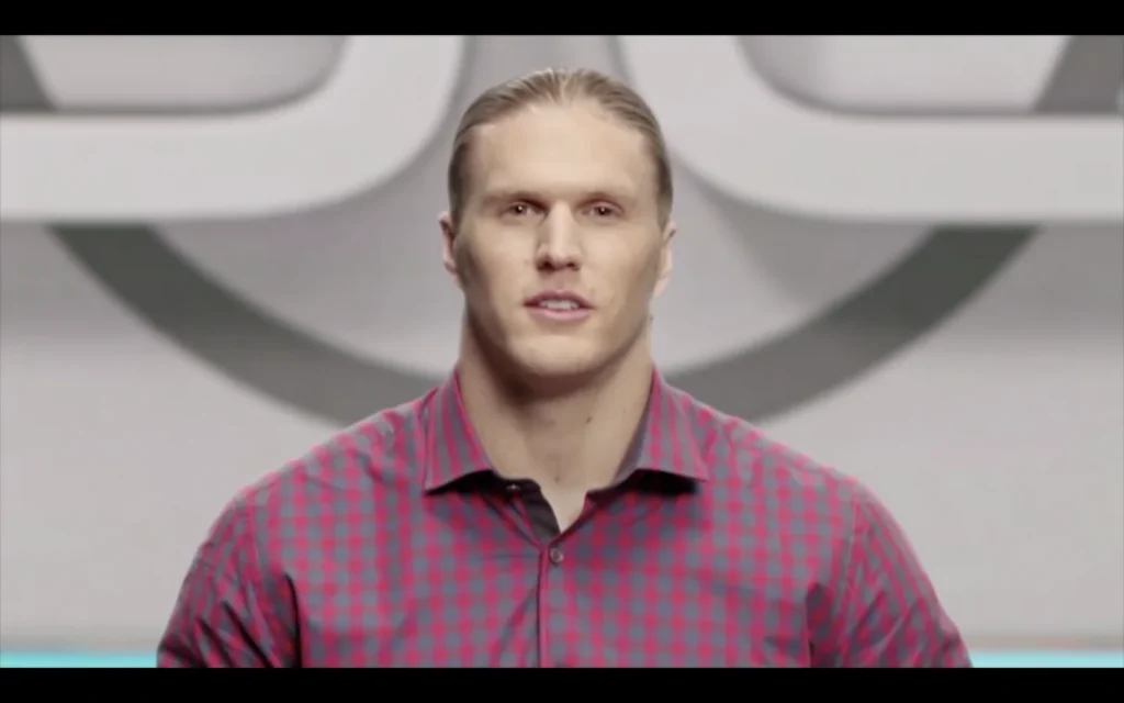 Close-up of a performer in a red checked shirt in the HBO Ballers commercial.