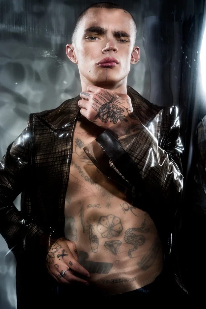 Portrait with smoky eye makeup, a dark leather jacket and reflected distortions in the Mylar surface.