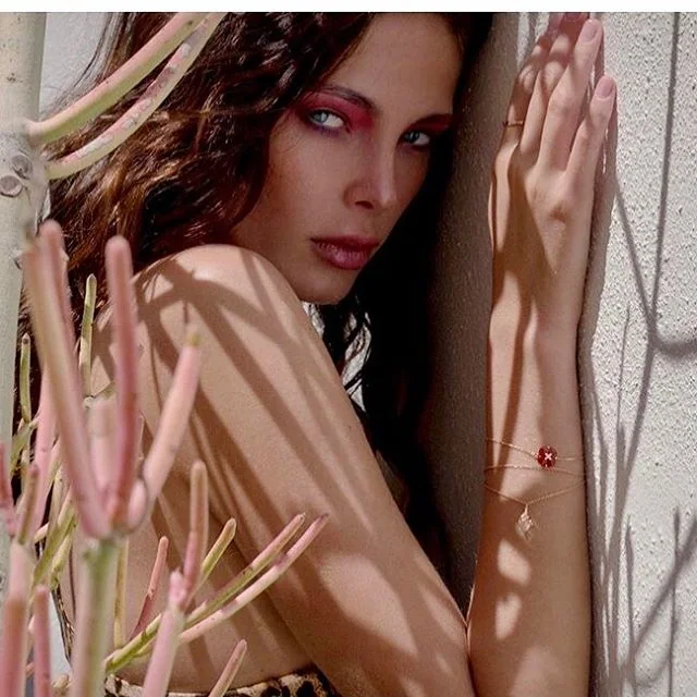 Fashion beauty portrait framed by dried flowers, with bronze eye makeup.